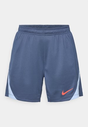 Shorts de sport navy fabriqués dans un tissu léger avec une finition texturée. Comprend une taille élastique et un logo Nike corail sur l'ourlet.