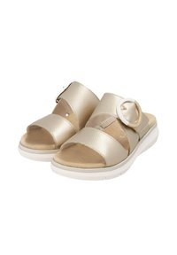 Gold textured sandals with two wide straps and a circular accent. Featuring a cushioned footbed and white, lightweight sole.