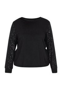 Maglietta nera a maniche lunghe con un corpino morbido e maniche con una texture di paillettes scintillanti. Presenta un colletto rotondo e polsini aderenti.