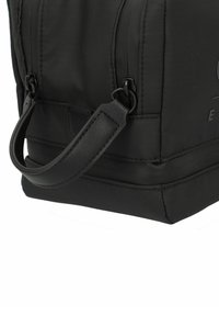 Zwarte rechthoekige tas van duurzaam nylon met een leren handvat, zijritssluiting en subtiele branding. Gebruikte textuur en versterkte naden.