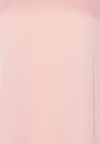 Soft, smooth fabric in light pink, featuring a simple, untextured design. The structure is a fluid, draped shape, with straight edges.