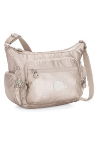 Beige nylon crossbody bag with adjustable strap, multiple zippered pockets, smooth texture, and decorative hardware accents.