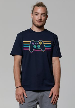 Navy cotton t-shirt featuring a graphic of a game controller with colorful stripes in pink, yellow, and turquoise across the chest.