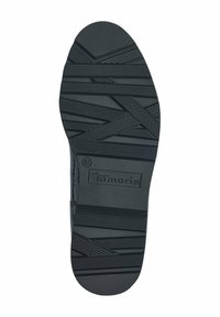 Suola di scarpa in gomma nera con pattern testurizzato, caratterizzata da scanalature orizzontali e diagonali per una migliore aderenza, contrassegnata con "Tamaris" e taglia 37.