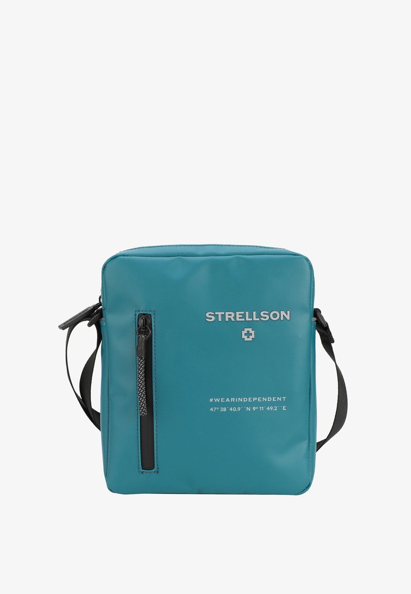 Borsa messaggera quadrata color blu petrolio, realizzata in materiale liscio e impermeabile. Presenta una tasca frontale con cerniera, una tracolla regolabile e dettagli in logo impresso.