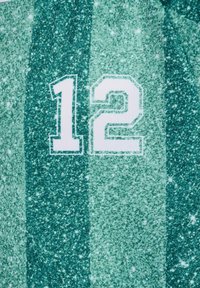 Number 12 printed in white on green vertical striped fabric with speckled texture and small light spots.