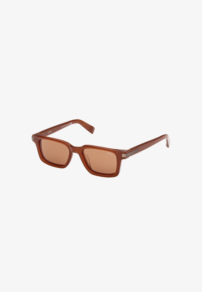 Brown, square-frame sunglasses with tinted lenses and metal accents on the temples. The material appears glossy and smooth in texture.