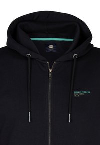 Sudadera con cremallera negra hecha de una mezcla de algodón, con un forro interior turquesa, cremallera plateada y texto verde en la parte frontal.
