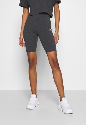 Kolenpak in een antracietgrijze kleur, gemaakt van een katoenmix, aansluitend ontwerp, met een klein oranje logo op de linker dij, gladde textuur.