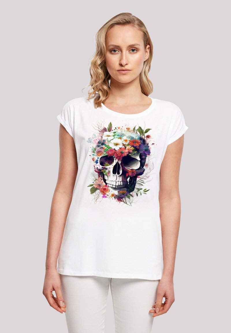 White cotton t-shirt featuring a colorful floral skull graphic, with floral accents in pink, purple, and green, short sleeves, and round neckline.
