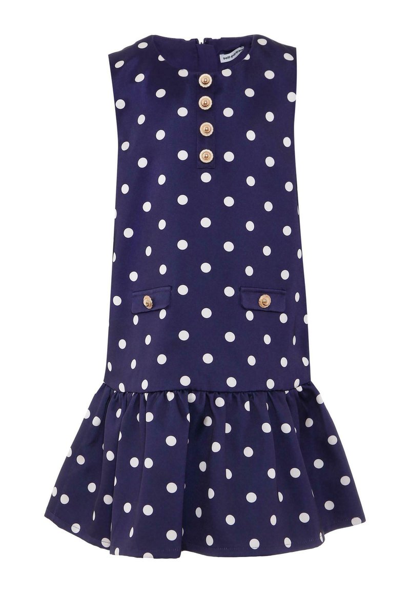 Granatowa sukienka w biały groszek, bez rękawów, z zapięciem na guziki z przodu, dwoma kieszeniami z przodu i falbaną na dole.