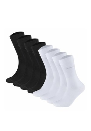Four black and four white crew-length socks arranged in two rows, side by side, on a white background.
