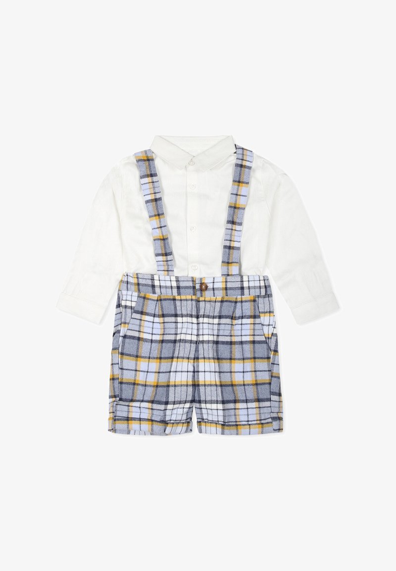 Chemise blanche à col avec un short en tartan gris et jaune, doté de bretelles et d'un bouton à l'avant. Tissu doux avec des détails en motif à carreaux.