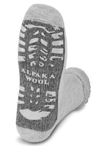 Grau gestrickte Wollsocke mit Gummi-Rutschpunkten an der Sohle. Verfügt über verstärkte Zehen- und Fersenpartien, kontrastierende Textur und "Alpaka-Wolle"-Markierung.
