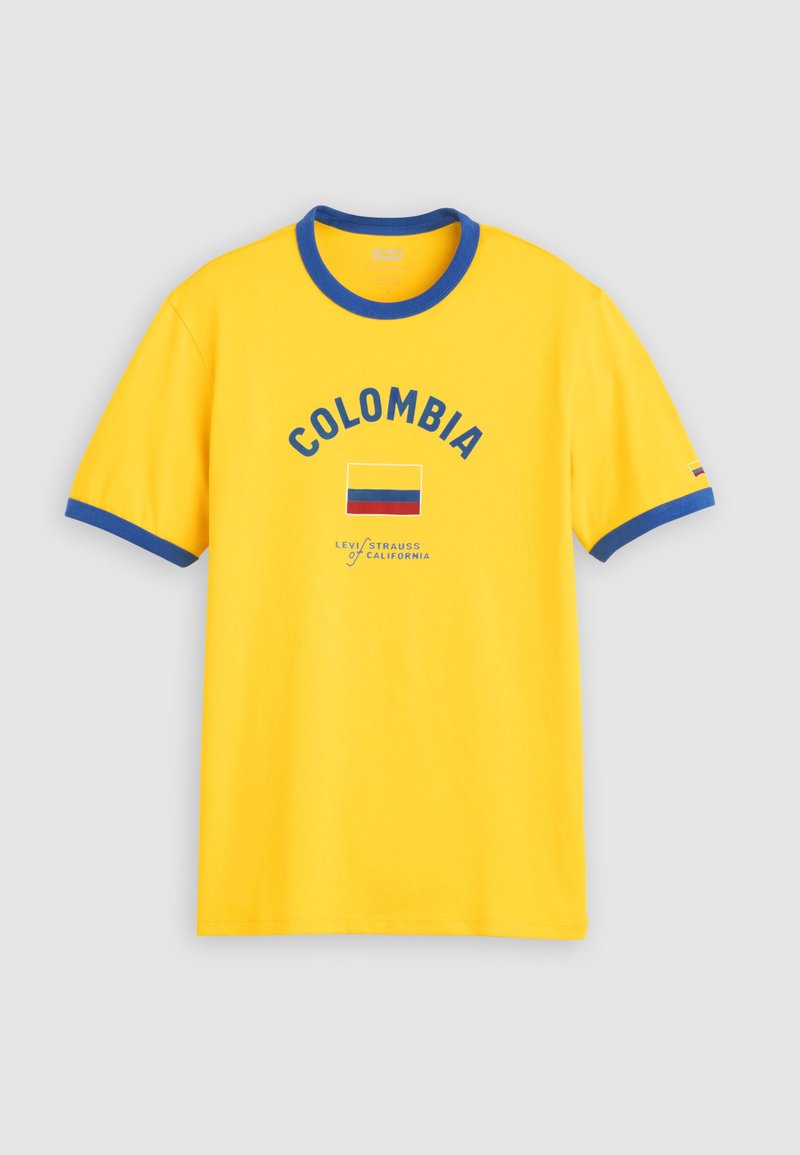 T-shirt jaune avec col et bords de manches bleus, avec le texte "COLOMBIA" et un motif du drapeau colombien sur le devant.