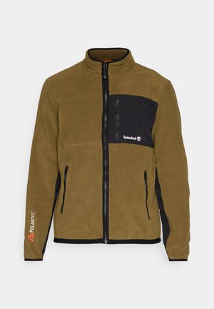 Polarowa kurtka w oliwkowej zieleni z czarnymi akcentami. Posiada kieszeń na zamek na piersiach, dwie boczne kieszenie oraz logo "Polartec" na rękawie.