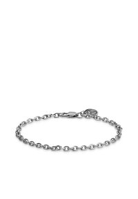 Silver chain bracelet with oval links, featuring a secure clasp and a small circular charm attached, set against a plain background.