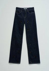 Jean en denim bleu foncé avec une coupe droite, décoré de motifs floraux en sequins noirs sur l'ensemble du tissu.