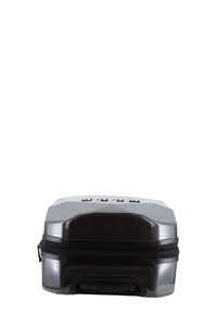 Hard-shell suitcase in dark gray plastic, featuring a geometric design, a zipper closure, and a retractable handle at the base.