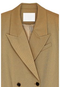 Tan double-breasted blazer with wide notch lapels, two black buttons, and a chest welt pocket, featuring a subtle diagonal weave texture.