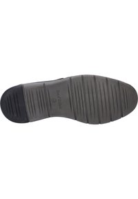 Suela de zapato de goma negra con surcos horizontales y verticales para tracción, con un logotipo y una impresión de tamaño en el costado.
