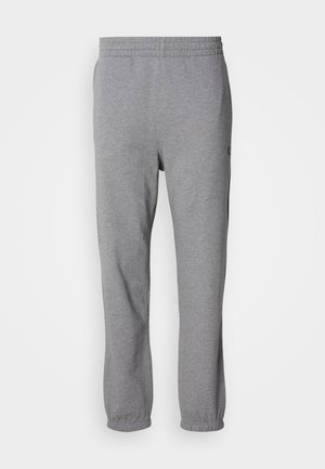 Grijze sweatpants gemaakt van zachte stof, met een elastische tailleband, taps toelopende benen en een logo bij het zakgebied.