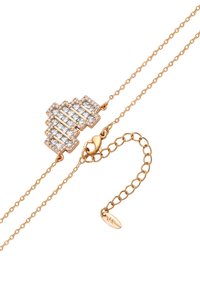 Guldtonet armbånd med et zigzag-design prydet med klare cubic zirconia-stene. Kædelink med en kædeklips og justerbar længde.