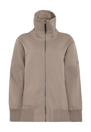 Beige jakke med lynlås og høj krave, lavet af blødt stof. Har ribstrikkede ærmekanter og et sømløst design, der giver et moderne udseende.