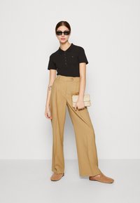 Tommy Hilfiger 1985 SLIM - Polo - black