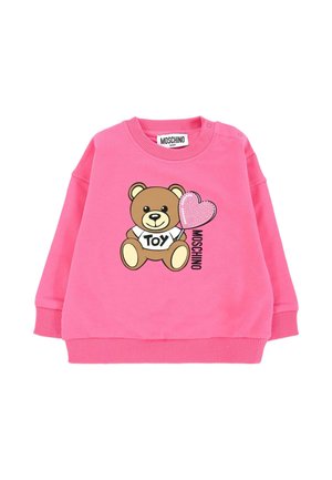 Felpa rosa baby con un orsetto che tiene un palloncino a forma di cuore in paillettes, la scritta "TOY" sulla maglietta dell'orsetto e il testo "MOSCHINO" accanto.