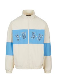 Cream windbreaker jacket with blue horizontal stripes and "FUBU" logo. Features a high collar, zip front, and elastic cuffs. Lightweight fabric.