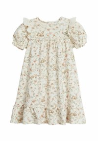 Blommig barnklänning i krämfärg, med volangkrage och volanger på ärmarna. Den har ett tryckt mönster av små djur och blommor.