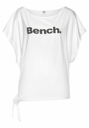 White oversized t-shirt with a wide neckline and short sleeves, features a prominent black "Bench." logo. Includes a side tie detail.