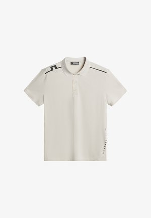 Pikétröja, ljusbeige, kortärmad, krage, svarta detaljer på axlar och sida, tillverkad av slät tyg, har logotryck på vänster sida.