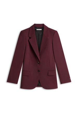 Damescolbert op maat in diep bordeauxrood met inslagkragen, twee voorknopjes, klepzakken en een zwart patroon voering aan de binnenkant.