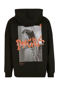 Haut à capuche noir avec un grand imprimé graphique au dos, représentant une silhouette sur une échelle, avec un texte orange indiquant "DANGEREUX." Matière en coton.