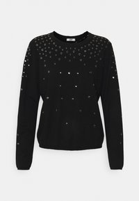 Sweat-shirt noir à manches longues avec un col rond, orné de sequins argentés réfléchissants en dégradé sur la poitrine.