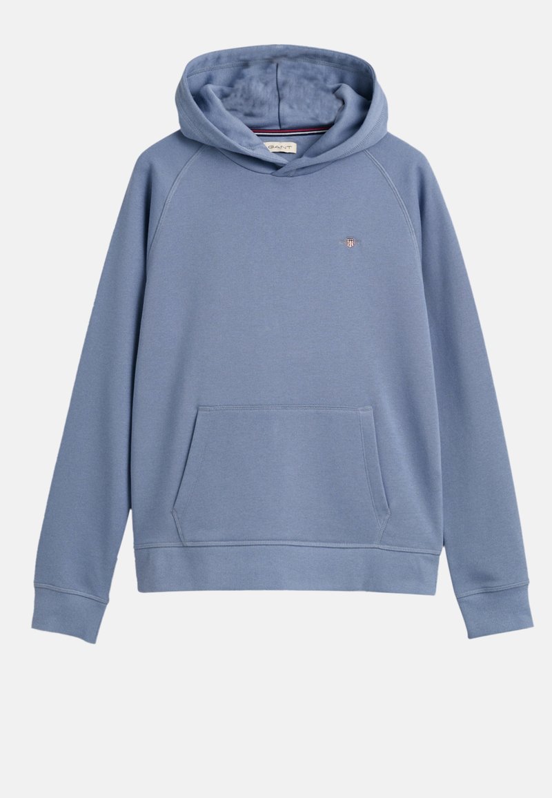 Sweat à capuche bleu en coton doux, avec une poche kangourou, des poignets côtelés et un petit logo sur la poitrine gauche. La capuche est doublée à l'intérieur.