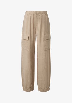 Beige cargo pants with an elastic waist, two side pockets, textured fabric, and tapered cuffs at the ankles.