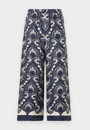 Pantalon large bleu marine avec motif floral et feuillage blanc, taille élastique et bordure bleu marine à l'ourlet.