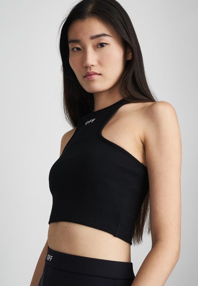 Top court noir à côtes avec un design asymétrique unique, présentant une encolure haute et le mot "OFF" brodé à l'avant.