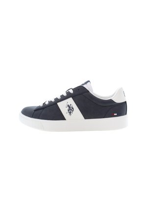 Zapatilla de cuero azul marino oscuro con detalles en blanco, suela blanca plana y logo lateral. Presenta una textura suave, punta redonda y seis ojales para los cordones.