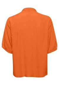 Chemise à manches courtes coupe ample en orange vif uni avec un col plat, vue de dos.