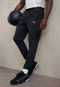 Puma FLEX CARGO PANT - Pantalon de survêtement - black