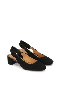 Black suede slingback shoes with a pointed toe, low block heel, and a decorative knot detail on the strap. Inside is a smooth tan lining.