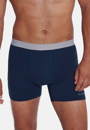 Marineblaue Boxershorts aus weichem Stoff, mit einem grauen elastischen Bund und einer taillierten Passform. Markenlogo auf dem Bein bedruckt.