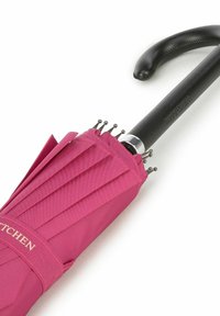Compact pink umbrella with pleated fabric, silver metal accents, and a black curved handle. Features metallic tips on ribs.