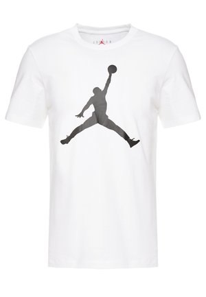Balta kokvilnas T-kreklā ar lielu melnu Jumpman logo, kas drukāts centrā. Īsās piedurknes un apaļā kakla dizains.