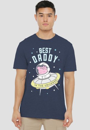 Navy cotton T-shirt featuring a cartoon design of a pig in a spacesuit on a spaceship, with text "BEST DADDY IN THE UNIVERSE" and star accents.