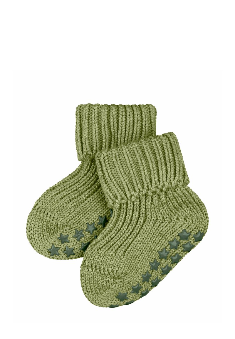 Grüne, gestrickte Babysocken mit einem gerippten Bündchen und sternmusterigem Gummi unter den Sohlen, entworfen für Komfort und Sicherheit.